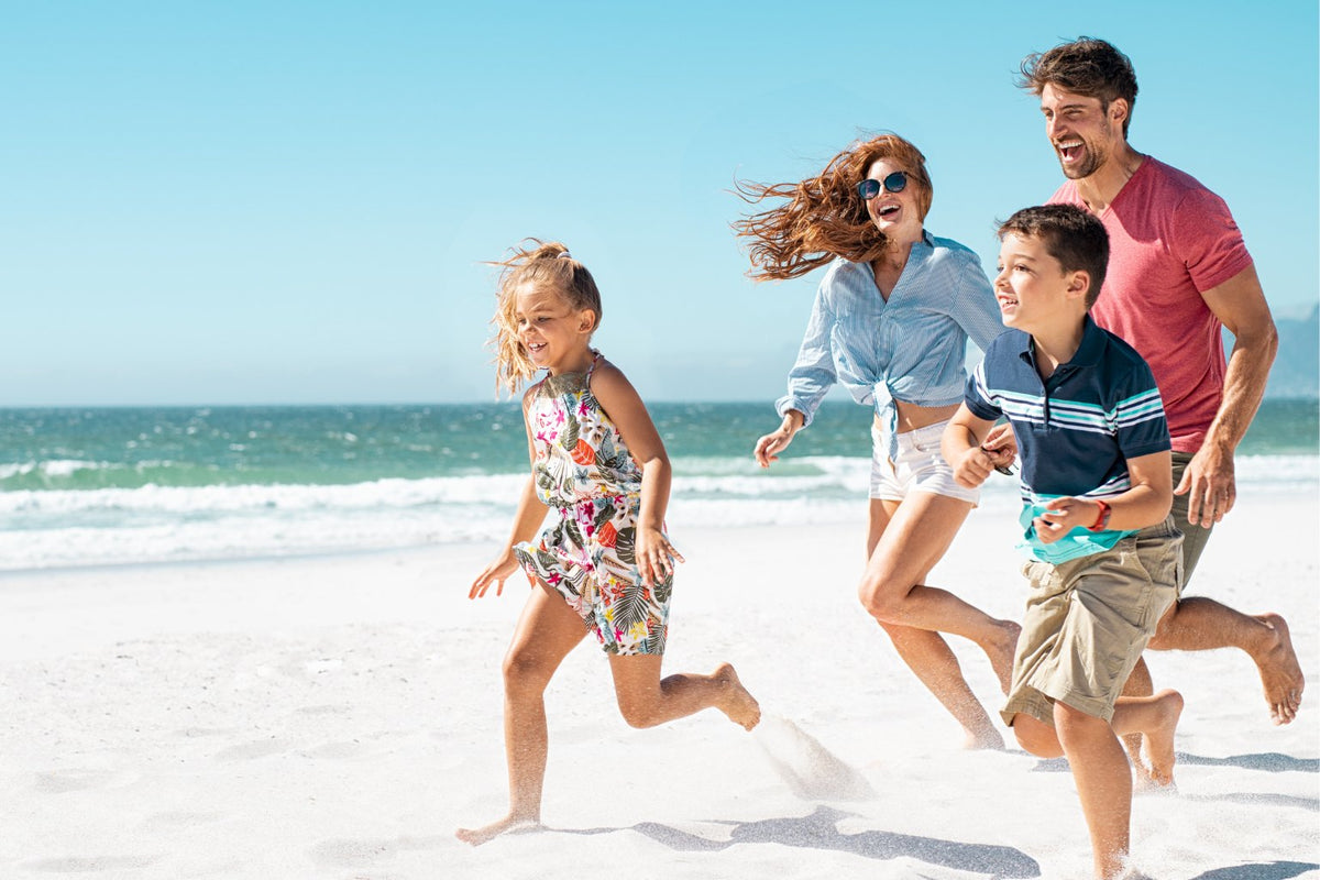 happy family running in the beach