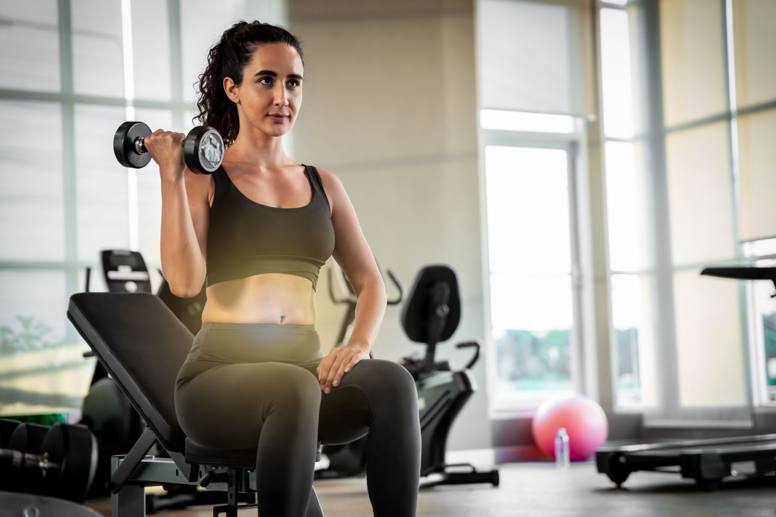woman doing dumbell exercise